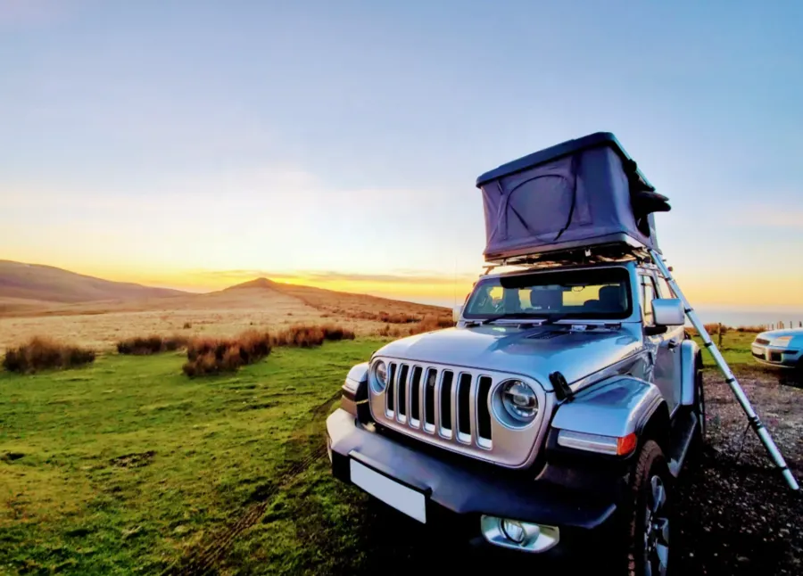 Rooftop tent on an SUV at sunset